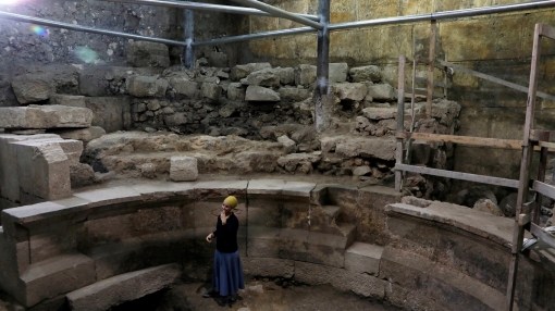Israel Antiquities Authority archaeologist Tehillah Lieberman stands inside a theatre-like structure during a media tour to reveal the structure which was discovered during excavation works underneath Wilson's Arch in Jerusalem's Old City